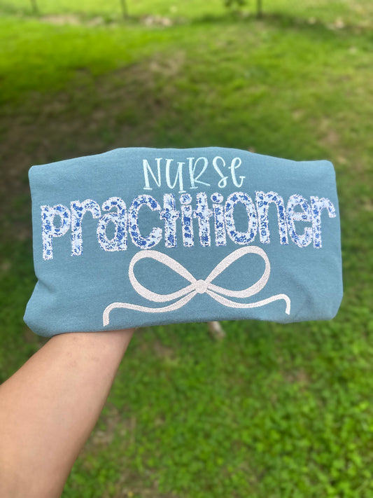 Floral appliqué nurse practitioner embroidered bow tee or sweatshirt